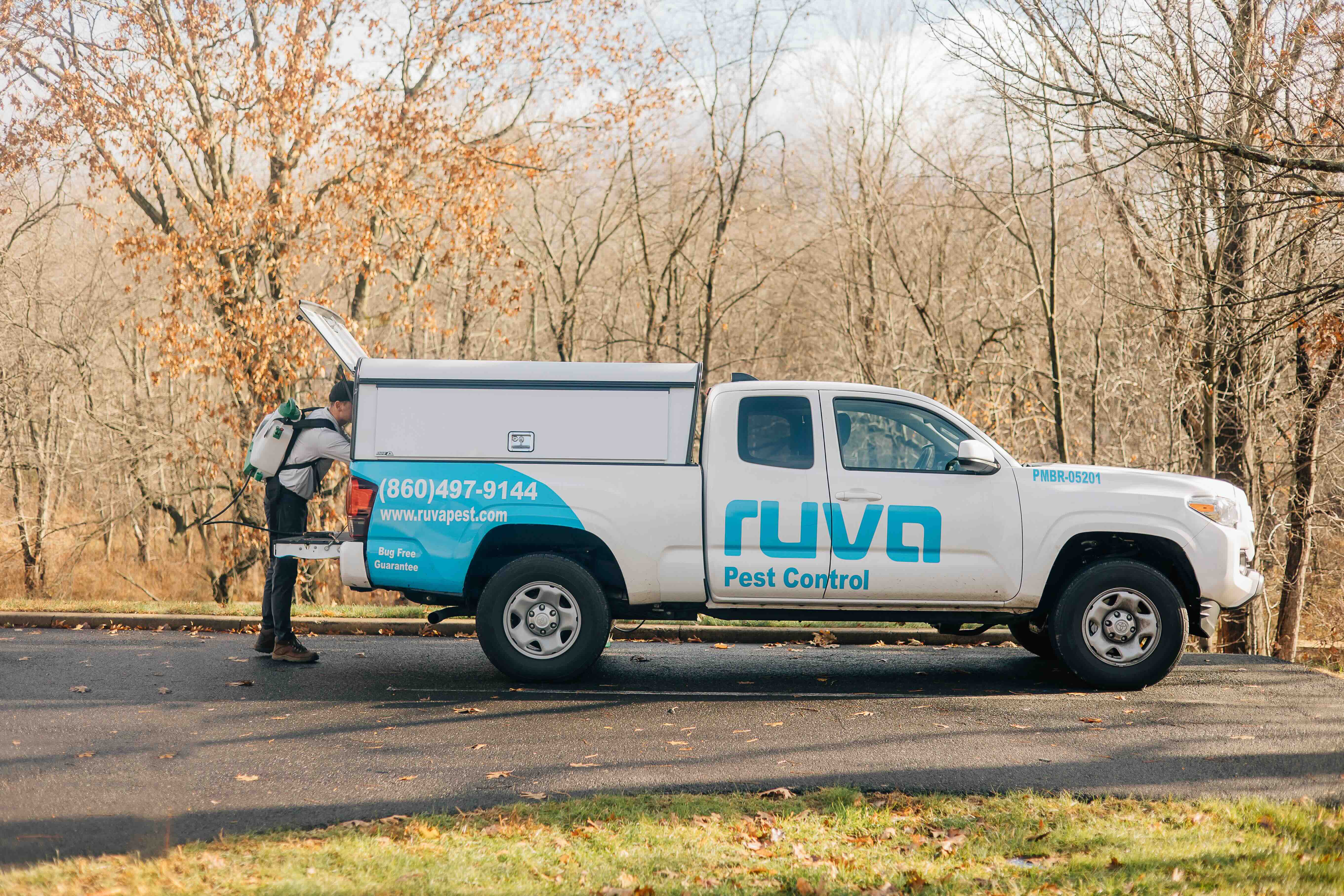 Ruva Pest Control technician with service truck in Danielson, CT